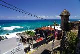 San_Juan_065_04142022 - Looking past a turret towards some beat up buildings in La Perla of Old San Juan