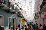 San_Juan_153_04142022 - Looking at the narrow lane underneath white butterflies in Viejo San Juan