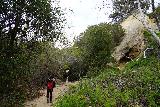 Santa_Ynez_Falls_015_02182023 - Julie and Tahia approaching a familiar 'cave' landmark along the Santa Ynez Canyon Trail during our February 2023 hike