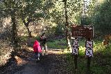 Santa_Ynez_Falls_017_01192019 - Julie and Tahia going past some signage telling us how far the Santa Ynez Falls was as seen in January 2019