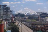 Seattle_17_039_07302017 - Looking over some freeway towards some bridges with Mt Rainier starting to emerge from the clouds in the background