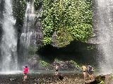 Sekumpul_056_iPhone_06222022 - Panoramic context of the Fiji Waterfall with Mom sharing the base with a group of dudes
