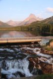 Swiftcurrent_Falls_003_08072017 - Contextual look at the uppermost drop of Swiftcurrent Falls and Swiftcurrent Lake on the other side of the bridge