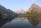 Swiftcurrent_Falls_043_08072017 - Looking over the reflections of Swiftcurrent Lake in the early morning towards Many Glacier Hotel in the distance