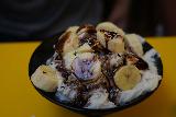 Taipei_544_06292023 - This was some kind of banana split sundae over condensed milk shave ice served up at the shave ice joint in Raohe Night Market that we chilled out at