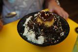 Taipei_545_06292023 - Looking at some kind of Oreo sprinkled shave ice in condensed milk served up at the shave ice joint at Raohe Night Market that we chilled out at