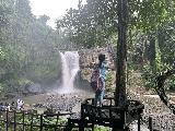 Tegenungan_009_iPhone_06172022 - Tahia standing on some kind of platform before the base of the Tegenungan Waterfall
