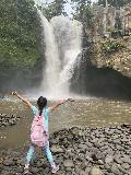Tegenungan_018_iPhone_06172022 - Tahia trying to do an Instagram pose before the base of the Tegenungan Waterfall