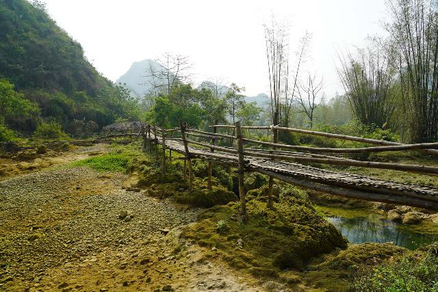 Thac_Co_La_027_04112025 - Context of the bamboo bridge going across the Quay Son River in front of the main tier of the Thac Co La Waterfall as well as over some smaller lower tiers