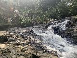 Tibumana_025_iPhone_06182022 - Looking upstream at a partial look at the cascade adjacent to the shrine infrastructure near the Tibumana Waterfall