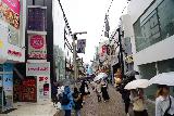 Tokyo_194_04062023 - Within the happening Takeshita Street in Harujuku District as people busted out umbrellas with the rain falling once again