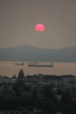 Vancouver_313_08012017 - The sun setting west of Vancouver beneath the smog on the horizon thereby starting to cut off the circular shape of the sun