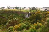 Waratah_Falls_17_008_12012017 - Focused on the full context of Waratah Falls surrounded by flowers in bloom with the Waratah town further upstream as seen during our December 2017 visit. Notice the track on the left side of this photo, which gave us the idea that we could hike to the waterfall's bottom