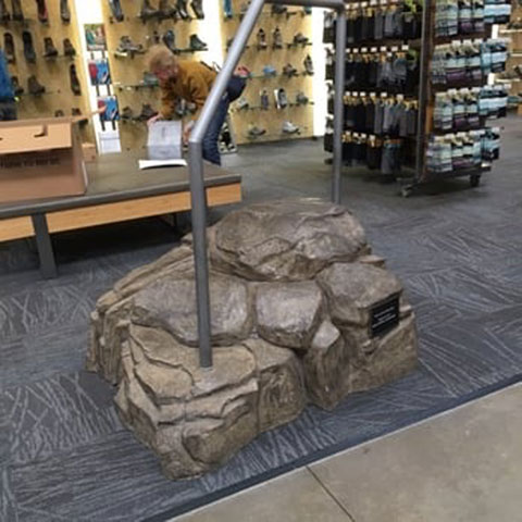 Simulated boulder or rocky incline at the shoe section of an REI store